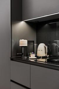 a kitchen with a counter with a toaster and a appliance at The Como City Golden Loft by Aura Luxury Collection in Como
