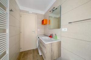 a bathroom with a sink and a mirror at Appartamenti I Profumi del Bosco in San Pietro di Cadore +44 photos