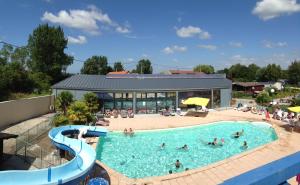 a group of people in a pool at a resort at gites des polders in Saint-Quentin-en-Tourmont