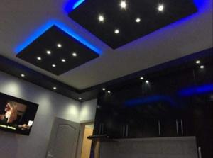 a living room with blue lights on the ceiling at Lola Jagodina in Jagodina