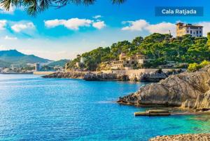 a view of a body of water with houses at Leon in Portocolom