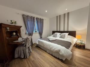 a bedroom with a large bed with blue curtains at Le Luxury - 24h du Mans - 11pers - Rêve au Mans in Ruaudin
