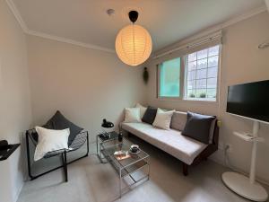 a living room with a couch and a tv at Staymuk Seochon, Center of Seoul in Seoul