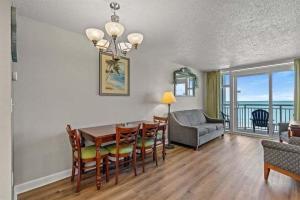 a living room with a table and chairs and a couch at Spacious 2 bedroom Direct Ocean Front Condo, Corner Unit, Balconies HSS 5th FL in Myrtle Beach