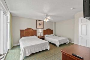a hotel room with two beds and a ceiling fan at Spacious 2 bedroom Direct Ocean Front Condo, Corner Unit, Balconies HSS 5th FL in Myrtle Beach +34 photos