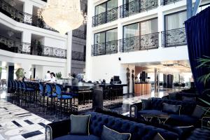 a hotel lobby with black furniture and a chandelier at Luxury Premium Finese in Golem