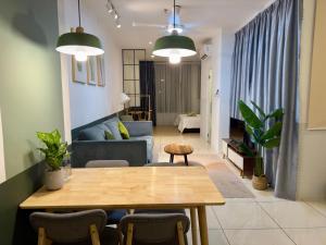 a living room with a table and a couch at Manhattan Suites, Itcc in Penampang