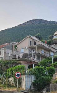 a large house with a sign in front of it at Apartman Palma in Kumbor