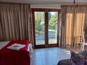 a room with a bed and a sliding glass door at 109 Mauser Avenue in Pretoria