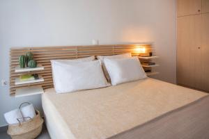 a bedroom with a large bed with white pillows at Georgia's House in Galatas +22 photos