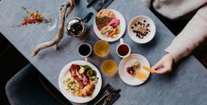 a table with plates of food on it at Lapland Hotels Kilpis in Kilpisjärvi