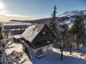 a house with snow on the roof in the snow at Chalet rénové pour 10 pers. avec Parking proche Super Besse - FR-1-814-102 in Besse-et-Saint-Anastaise