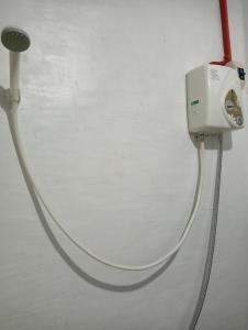 a white hose is hooked up to a wall at RM Homestay in Siquijor
