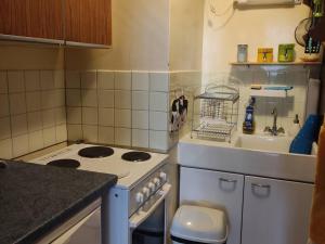 a small kitchen with a stove and a sink at Studio confortable au pied des pistes avec terrasse - FR-1-804-55 in Enchastrayes +3 photos