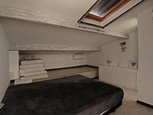 a bedroom with a bed and a skylight at Maison pour 10 pers. à 300m de la mer, Saintes-Maries-de-la-Mer - FR-1-475-202 in Saintes-Maries-de-la-Mer +5 photos