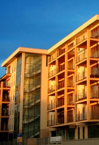 a large building with balconies on the side of it at Dunalux Apartman in Győr