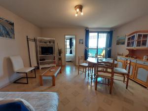 a living room with a table and a dining room at Appartement T2 au centre de Vieux-Boucau avec parking privé, proche des plages - FR-1-239-1136 in Vieux-Boucau-les-Bains