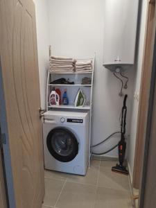 a washing machine in a corner of a room at Condo Santosha on the beach in Pomorie