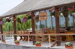 a pavilion with potted plants and a sign on it at Pensiunea Paradise Delta House in Fîntîna Dulce