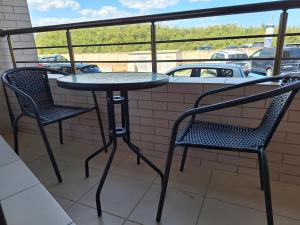 a table and two chairs sitting on a balcony at Condo Santosha on the beach in Pomorie