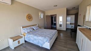 a bedroom with a king sized bed and a kitchen at Bubbles Villa Kathisma Beach View Lefkada in Agios Nikitas