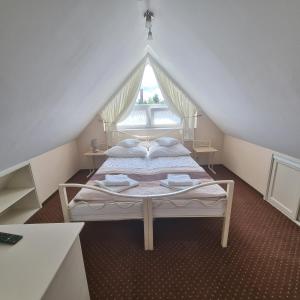 a bedroom with two beds in a attic at Willa Baja in Łeba +37 photos