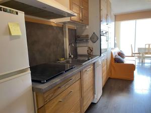 a kitchen with a sink and a stove at Studio rénové avec loggia et parking privatif - FR-1-553-306 in Balaruc-les-Bains