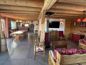 a large room with tables and chairs in a building at Chalet individuel Les Saisies pour 12 pers., superbe vue Mont Blanc - FR-1-594-334 in Hauteluce