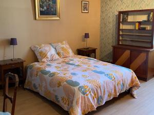a bedroom with a bed with a colorful comforter at Grande Maison Familiale avec Piscine et Parking à Saint-Gaultier - FR-1-591-753 in Saint-Gaultier +27 photos