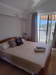 a bedroom with a bed with towels on it at Planika Apartments 2 in Korčula