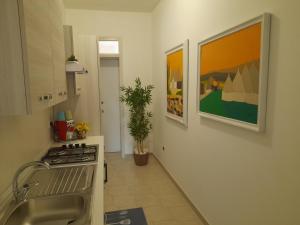 a kitchen with a sink and a stove top oven at CASA VACANZA "Adamo" in Racale