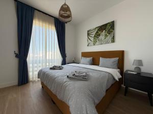 a bedroom with a bed and a large window at Terra in Elea +204 photos