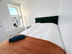 a bedroom with a bed with a pillow on it at Southsea 4-Bed Seaside Retreat- Sleeps 11 & Garden in Southsea +21 photos