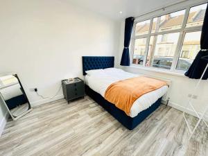 a bedroom with a bed and a window at Southsea 4-Bed Seaside Retreat- Sleeps 11 & Garden in Southsea