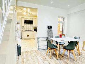 a kitchen and dining room with a table and chairs at Southsea 4-Bed Seaside Retreat- Sleeps 11 & Garden in Southsea