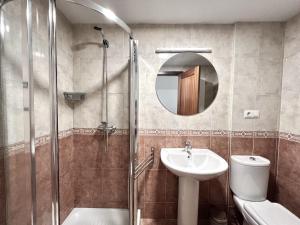a bathroom with a shower and a sink and a toilet at BaruHaus Piscina Terraza y Parking Rianxo in Rianjo +12 photos