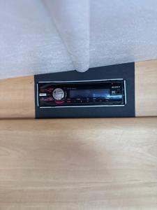 a black radio sitting on top of a wooden floor at Przyczepa Kempingowa - 4-6os , Jastarnia by WoDo Camp in Jastarnia