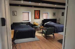 a living room with two beds and a couch at Serengeti & Stayover in Svebølle
