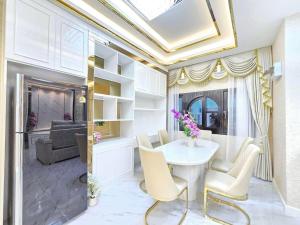 a living room with a table and chairs and a couch at Marina Villa, North Pattaya in Pattaya North