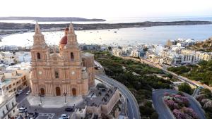an aerial view of a building in a city at Luna Holiday Complex in Mellieħa