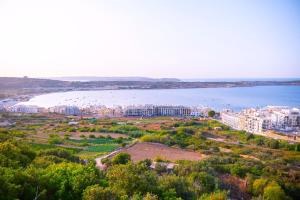 an aerial view of a city and a body of water at Luna Holiday Complex in Mellieħa