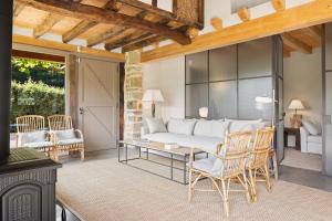 a living room with a couch and a table and chairs at OAR Cottage in Durango