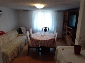 a living room with a table and a couch at Holiday Home Vucina in Sveti Juraj