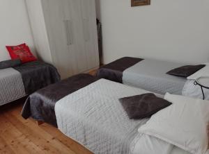 a room with two beds and a couch at Holiday Home Vucina in Sveti Juraj
