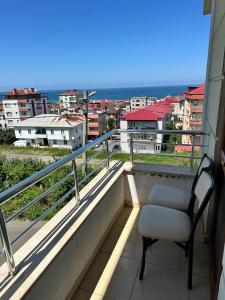 a chair on a balcony with a view of the ocean at ST Apart in Pelitli