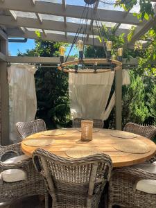 a wooden table with chairs and a chandelier at Siedlisko Belfort - Dom Wschodów in Schodno +34 photos
