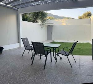 a patio with a table and chairs on a patio at SALOU on the Beach in Ipsos