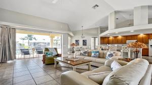 a living room with two couches and a table at Boaters Dream S. Terr Pool Yacht Club Boating in Cape Coral