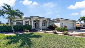 a house with a palm tree in a yard at Boaters Dream S. Terr Pool Yacht Club Boating in Cape Coral +55 photos