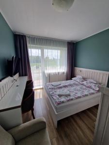 Łóżko lub łóżka w pokoju w obiekcie AGIS Pokoje Gościnne